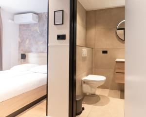 a small bathroom with a bed and a toilet at Hotel van Gelder in Amsterdam