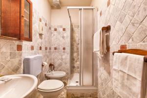 a bathroom with a toilet and a sink and a shower at Hotel Portacavana in Trieste