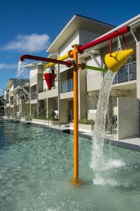 a yellow fire hydrant in the middle of a swimming pool at 1770 Lagoons Central Apartment Resort in Agnes Water