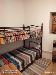 two bunk beds in a room with a rug at Angel's Traditional House 