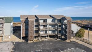 an aerial view of a building with the ocean in the background at High Dunes in Kill Devil Hills
