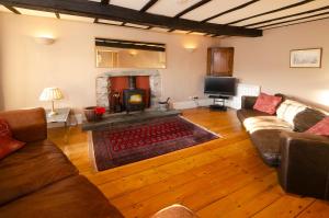 a living room with a couch and a fireplace at The Old White Lion, Chapel Stile in Chapel Stile