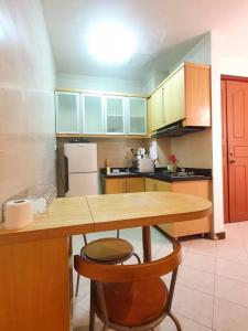 a kitchen with a wooden table and a counter top at [HERITAGE 5] HOMESTAY Studio 4Pax, FREE WIFI in Seri Kembangan