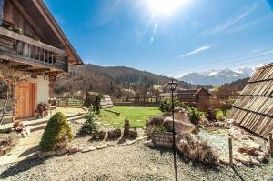 a garden with a pond in front of a house at Apartments JULIA Bohinj in Bohinj