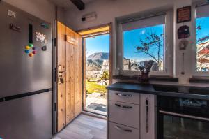 a kitchen with a view of a mountain through a window at Apartments JULIA Bohinj in Bohinj