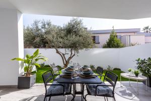 a table and chairs on a patio at Colombo Palace - viale colombo 358 in Quartu SantʼElena