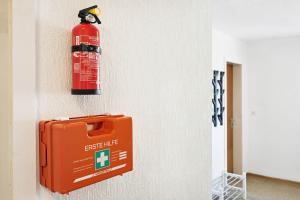 a fire extinguisher is hanging on a wall at Monteurwohnungen am Neckar in Köngen