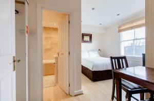 a bedroom with a bed and a table and a dining room at Beresford Road London Rooms in London +21 photos