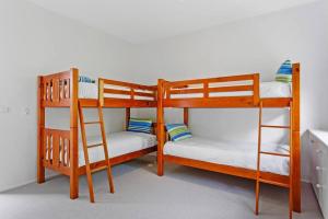 two bunk beds sitting next to each other in a room at Coastal Cool -Pool, Tennis Court in Sorrento