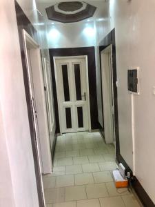a hallway with a door and a tiled floor at Al Amana in Dakar