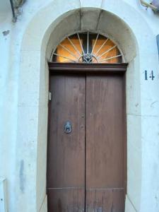 a large wooden door in a building with an arch at Bilocale in centro a Pietrelcina in Pietrelcina
