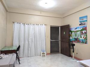 a room with a shower and a white curtain at Violin Mountain in Dumaguete