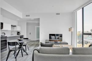 a white living room with a table and chairs at Hollywood 2BR w Roof BBQ nr MelroseFairfax LAX-890 in Los Angeles