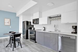 a kitchen with white cabinets and a table in it at Hollywood 2BR w Roof BBQ nr MelroseFairfax LAX-890 in Los Angeles