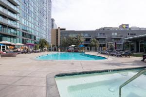 a large swimming pool in the middle of a city at Downtown 1BR w Pool Gym nr Staples Center LAX-625 in Los Angeles