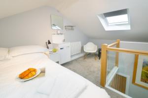 a bedroom with a bed with a plate of donuts on it at Cherry Tree Cottage in Chapel Stile