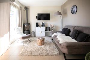 a living room with a couch and a table at IseoLakeRental - Casa Amata in Riva di Solto