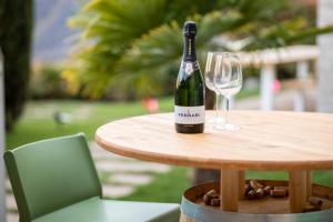a bottle of wine sitting on a table with a glass at IseoLakeRental - Casa Amata in Riva di Solto