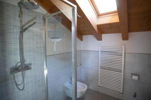 a bathroom with a shower with a toilet and a sink at IseoLakeRental - Casa Amata in Riva di Solto +24 photos