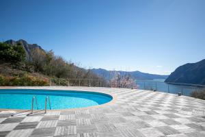 a swimming pool with a view of the water at IseoLakeRental - Casa Amata in Riva di Solto