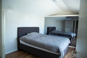 a bedroom with a bed and a mirror at Duplex Loft mit Panorama Seaview in Kusadası