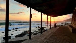 a person standing on a beach with the ocean at San Giuseppe Casa per Ferie in Quercianella