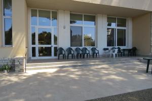 a group of chairs sitting outside of a building at San Giuseppe Casa per Ferie in Quercianella