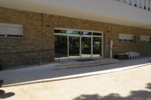 a brick building with sliding glass doors on it at San Giuseppe Casa per Ferie in Quercianella
