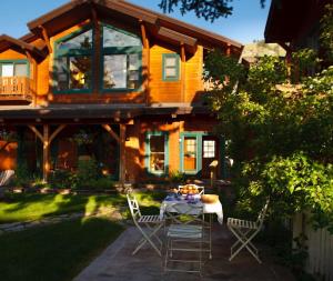 a house with a table and chairs in front of it at The Alpine House in Jackson