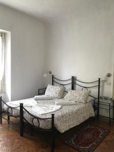 a bedroom with a black bed with pillows on it at Villa del Cigno in Lecco