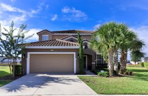 a house with a garage and palm trees at Solterra Resort - 6 Bed SOUTH FACING Pool Home - Clubhouse, Resort Pool & Cabanas by Orlando Holiday Rental Homes LLC 5423 in Davenport