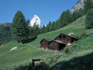 a barn on a hill with a mountain in the background at Apartment Pyrith by Interhome in Zermatt