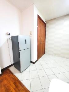 a kitchen with a refrigerator in a room at [HERITAGE 7] HOMESTAY Studio 4Pax, FREE WIFI in Seri Kembangan