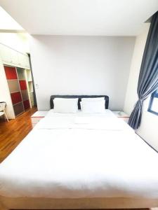 a bedroom with a large white bed in a room at [HERITAGE 7] HOMESTAY Studio 4Pax, FREE WIFI in Seri Kembangan