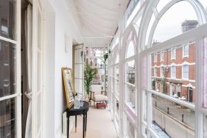 a hallway with windows and a desk with a computer at Beautiful City Centre Flat with Free Parking in Exeter