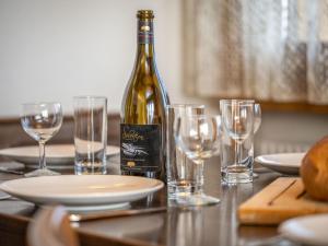 een fles wijn op een tafel met glazen bij Apartment Plein Soleil A 10 by Interhome in Ovronnaz