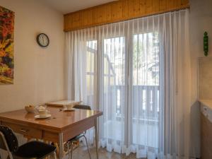 a dining room with a table and a large window at Apartment Plein Soleil A 10 by Interhome in Ovronnaz