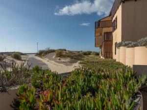 a building with plants next to a road at Apartment Les Maisons de l'Océan-9 by Interhome in Lacanau-Océan