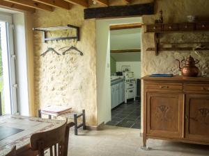 a kitchen with a table and a counter top at Gîte « le Sault-Poket » in Walcourt