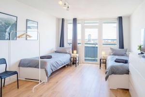 a bedroom with two beds and a window at Chic City-View Apartments in Hanau in Hanau am Main