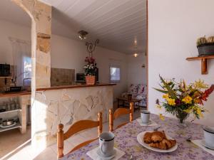 a kitchen with a table with a plate of food on it at Holiday Home Campestra by Interhome in Coti-Chiavari