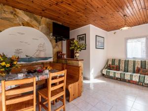 een woonkamer met een tafel en een bank bij Holiday Home Campestra by Interhome in Coti-Chiavari