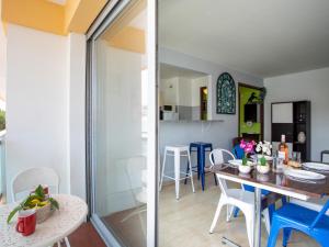 a kitchen and living room with a table and chairs at Apartment La Pinède-2 by Interhome in Puits