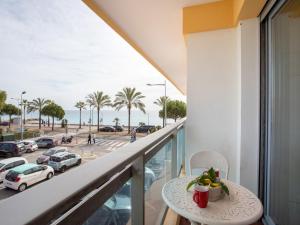 a balcony with a table with a bowl of fruit on it at Apartment La Pinède-2 by Interhome in Puits