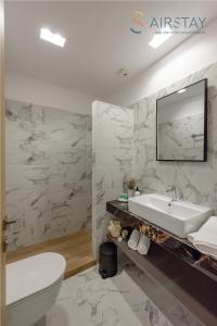 a white bathroom with a sink and a toilet at Zed Smart Property by Airstay in Spata