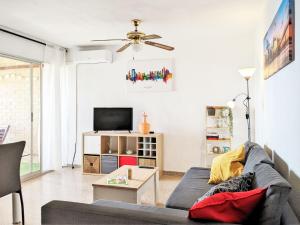a living room with a couch and a tv at Apartment Coblanca XVI by Interhome in Cala de Finestrat +21 photos