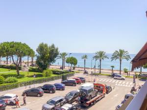 a parking lot with a lot of cars and a truck at Apartment La Pinède-1 by Interhome in Cagnes-sur-Mer