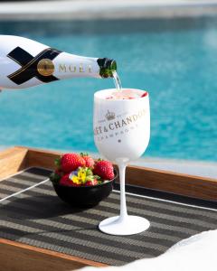 a bottle of wine is being poured into a wine glass at Hotel Faro, a Lopesan Collection Hotel - Adults Only in Maspalomas