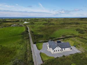 an overhead view of a large white house in a field at Melroche House Doolin in Doolin