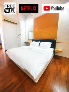a white bed in a room with aadobeadobeadobeadobeadobeadobe at [HERITAGE 9] HOMESTAY Studio 4Pax, FREE WIFI in Seri Kembangan